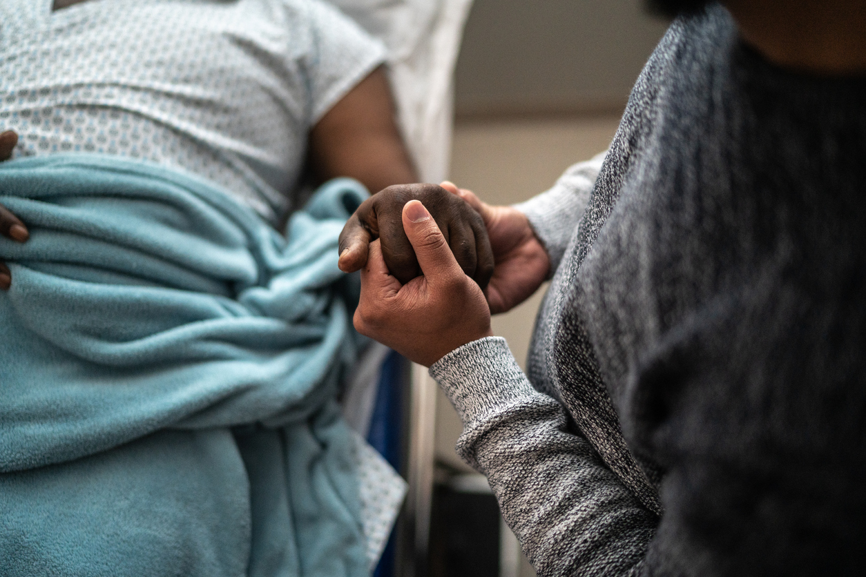 Image showing a family member holding hands of a patient in a hospital