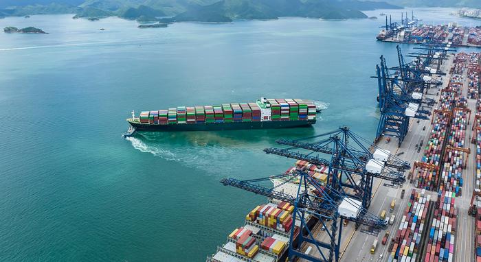 An aerial view of cargo container ships at port.