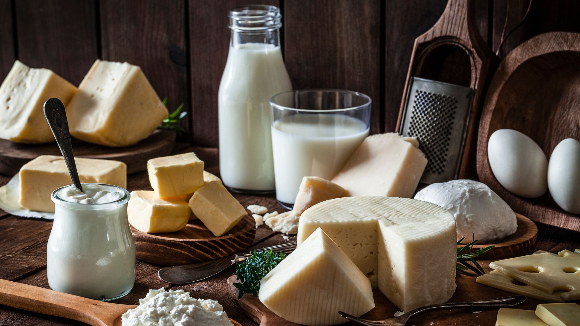 Dairy products assortment shot on rustic wooden table.