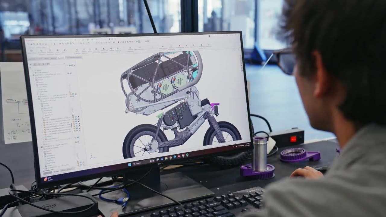 Photograph accompanying RAI Institute's bicycle robot does wheelies and front flips with five actuated degrees of freedom